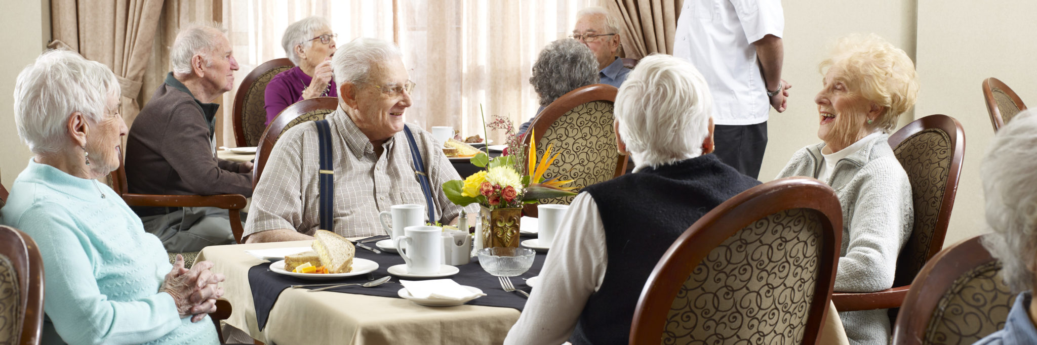 retirement residence, group of seniors eating dinner